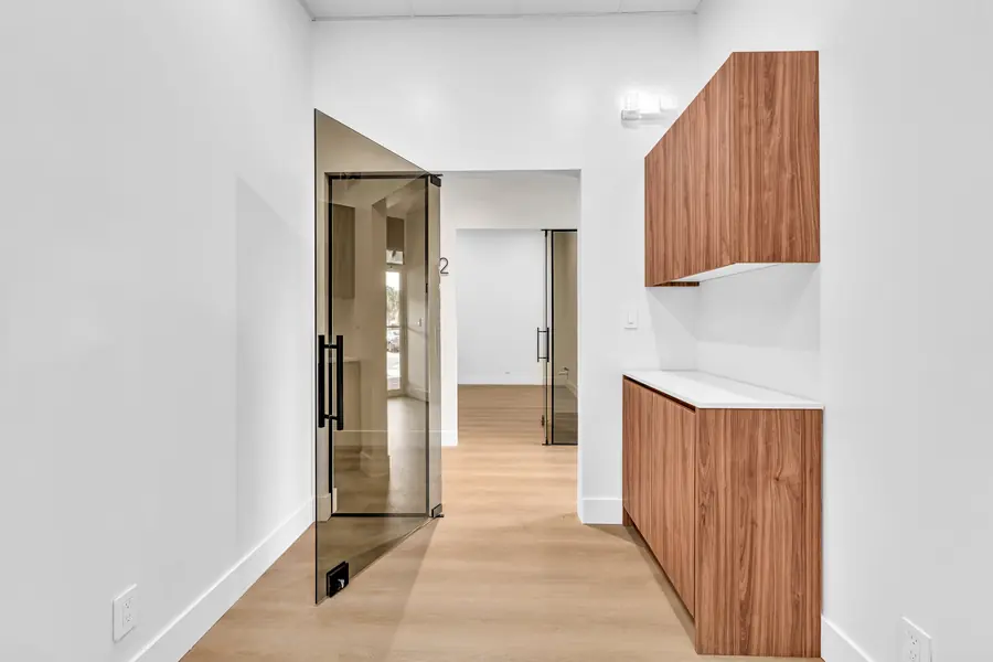 Suite with walnut cabinets, seen through its open smoked glass door