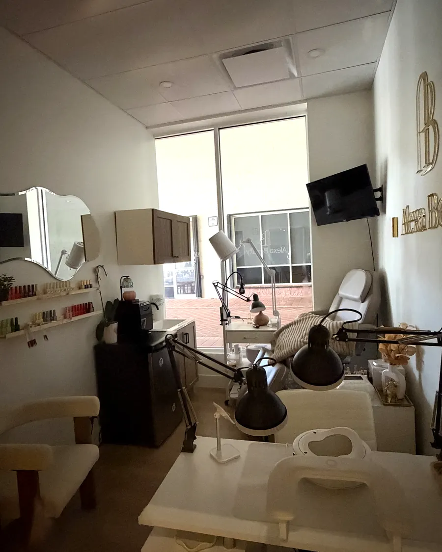 Esthetics and nail suite with a large window, treatment chair and manicure station